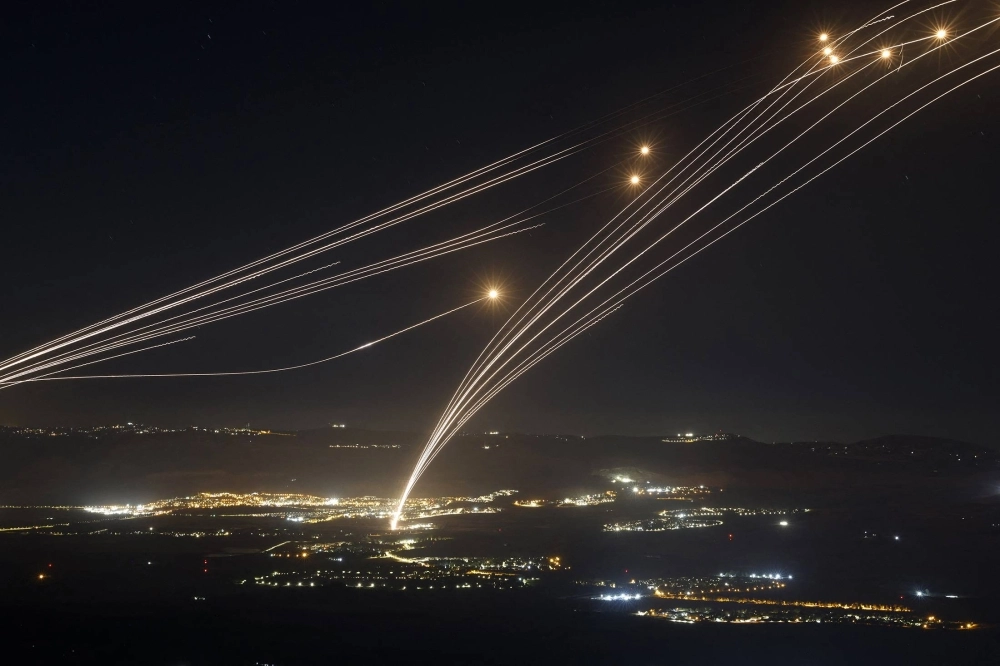 Rockets fired from southern Lebanon are intercepted by Israel’s Iron Dome air defense system over the Upper Galilee region in northern Israel on Sunday. Rockets fired from southern Lebanon are intercepted by Israel’s Iron Dome air defense system over the Upper Galilee region in northern Israel on Sunday.