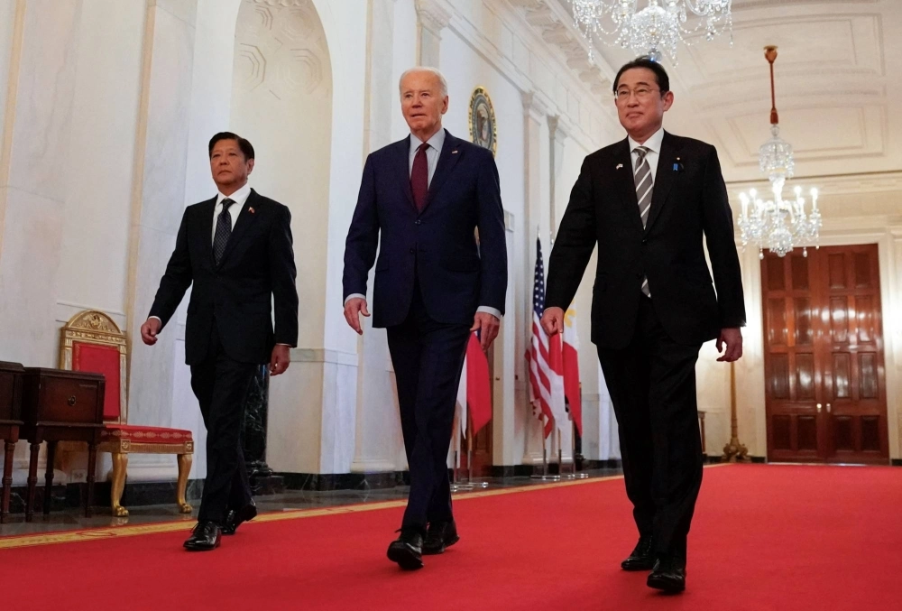 U.S. President Joe Biden escorts Philippines President Ferdinand Marcos Jr. and Prime Minister Fumio Kishida to their trilateral summit at the White House in Washington in April. U.S. President Joe Biden escorts Philippines President Ferdinand Marcos Jr. and Prime Minister Fumio Kishida to their trilateral summit at the White House in Washington in April.