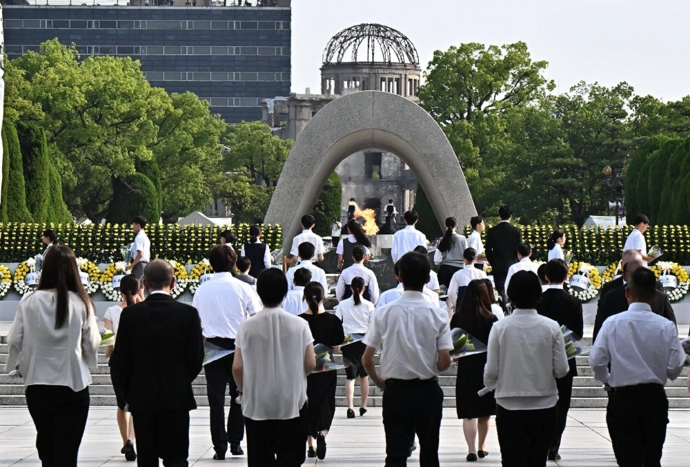 Hiroshima citizens place flowers at the Cenotaph, commemorating those lost in the atomic bombing of the city, on Tuesday, the 79th anniversary of the attack. Hiroshima citizens place flowers at the Cenotaph, commemorating those lost in the atomic bombing of the city, on Tuesday, the 79th anniversary of the attack.