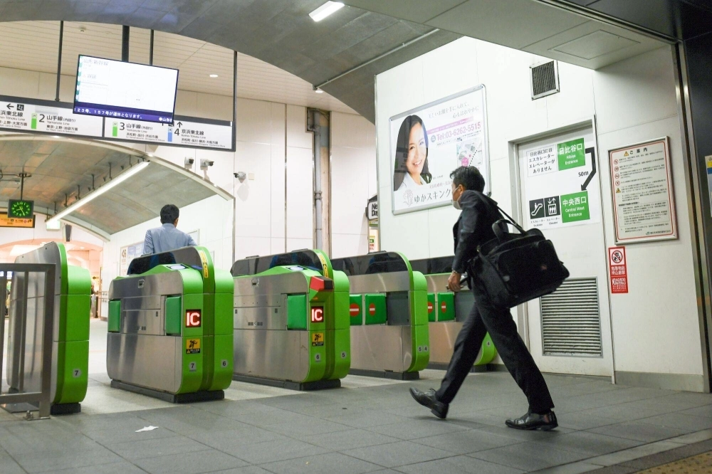 Passengers enter Yurakucho station in Tokyo on Friday. Passengers enter Yurakucho station in Tokyo on Friday.