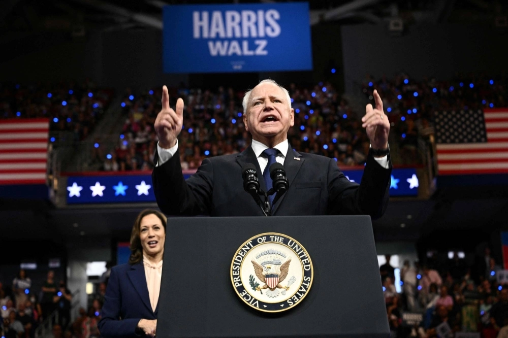 Minnesota Gov. Tim Walz, the U.S. Democratic vice presidential candidate, speaks as Vice President and 2024 Democratic presidential nominee Kamala Harris looks on at Temple University in Philadelphia on Tuesday. Minnesota Gov. Tim Walz, the U.S. Democratic vice presidential candidate, speaks as Vice President and 2024 Democratic presidential nominee Kamala Harris looks on at Temple University in Philadelphia on Tuesday.