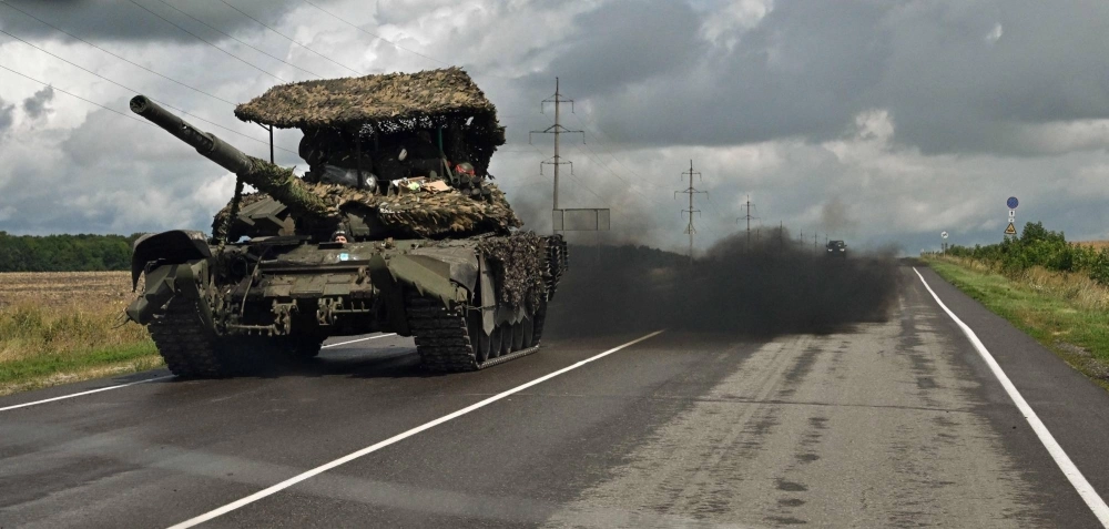 A Russian battle tank drives outside the town of Sudzha on Thursday.  A Russian battle tank drives outside the town of Sudzha on Thursday.