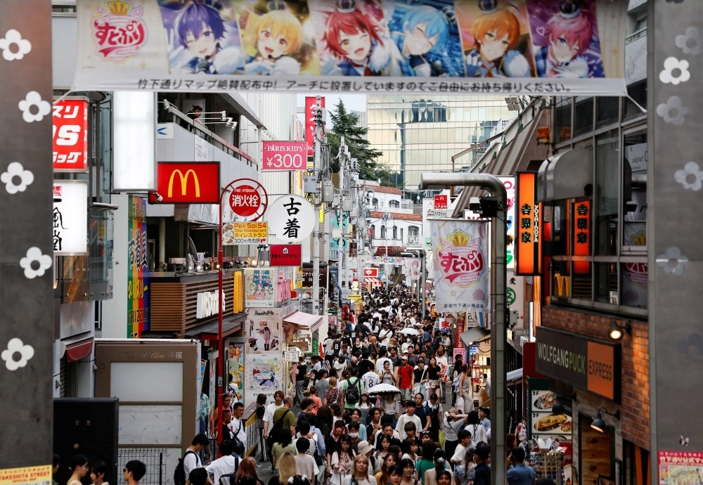 People walk along Takeshita street at Harajuku shopping area in Tokyo People walk along Takeshita street at Harajuku shopping area in Tokyo