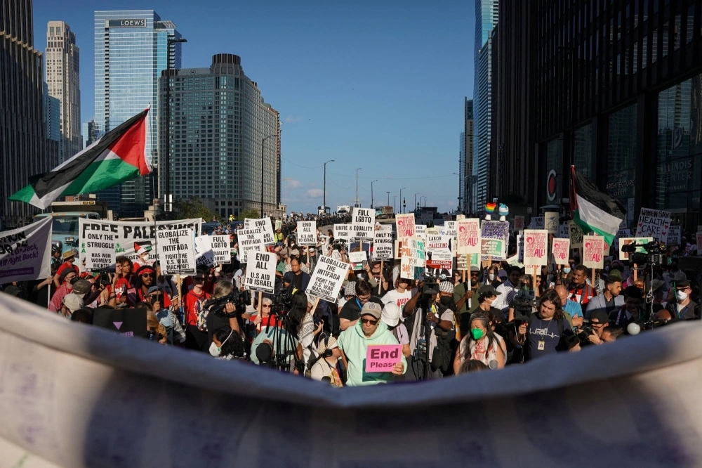 People take part in a protest organized by pro-abortion rights, pro-LGBT rights and pro-Palestinian activists, on the eve of the Democratic National Convention, in Chicago on Sunday. People take part in a protest organized by pro-abortion rights, pro-LGBT rights and pro-Palestinian activists, on the eve of the Democratic National Convention, in Chicago on Sunday.