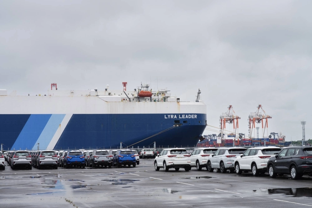 Vehicles bound for shipment parked in front of the Lyra Leader vehicles carrier ship at the Nagoya Port in Nagoya. Japan's exports rose in July but shipment volumes extended their declines. Vehicles bound for shipment parked in front of the Lyra Leader vehicles carrier ship at the Nagoya Port in Nagoya. Japan's exports rose in July but shipment volumes extended their declines.