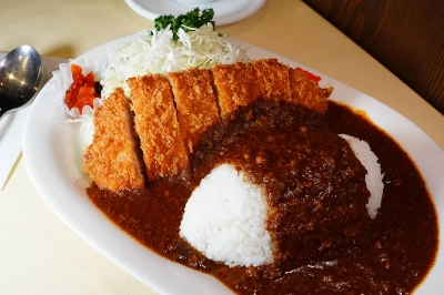 Three Tokyo restaurants claim to be the inventor of Japan's 'katsu karē' (breaded and fried pork served with Japanese curry), but Ginza Swiss' take (pictured) may be the most unique. Three Tokyo restaurants claim to be the inventor of Japan's 'katsu karē' (breaded and fried pork served with Japanese curry), but Ginza Swiss' take (pictured) may be the most unique.