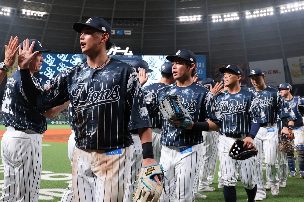 Lions players celebrate after a win over the Buffaloes on Wednesday at Belluna Dome in Tokorozawa, Saitama Prefecture.  Lions players celebrate after a win over the Buffaloes on Wednesday at Belluna Dome in Tokorozawa, Saitama Prefecture.