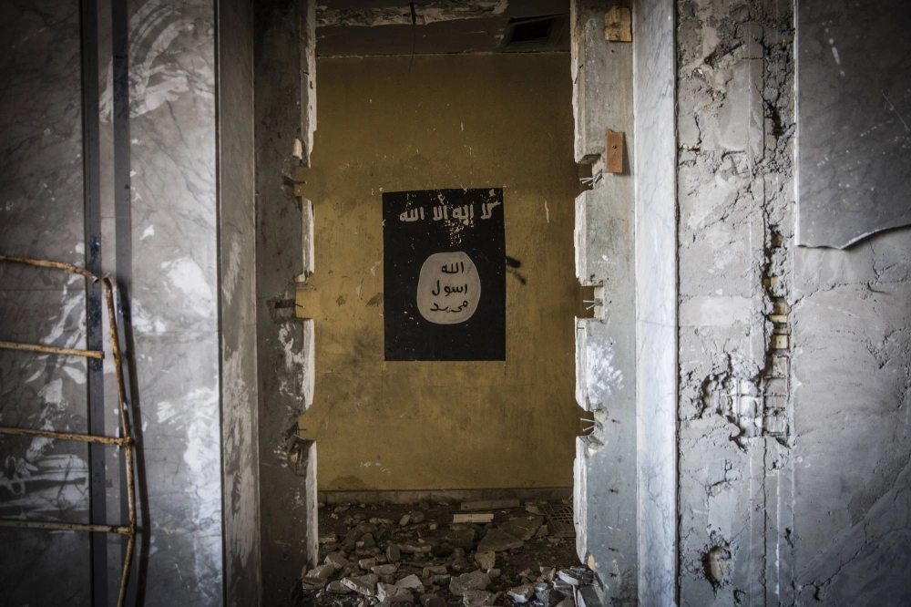 An ISIS flag hangs in the bombed-out remains of a palace that militants used as a headquarters in Mosul, Iraq, in 2017.  An ISIS flag hangs in the bombed-out remains of a palace that militants used as a headquarters in Mosul, Iraq, in 2017.