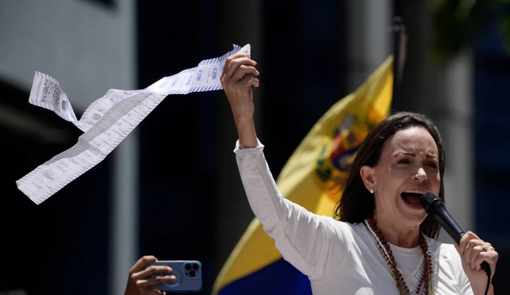 Venezuelan opposition leader Maria Corina Machado speaks as she holds up a copy of electoral records during a protest against the election results announced by President Nicolas Maduro's government after he was declared winner of the July election, in Caracas on Wednesday. Venezuelan opposition leader Maria Corina Machado speaks as she holds up a copy of electoral records during a protest against the election results announced by President Nicolas Maduro's government after he was declared winner of the July election, in Caracas on Wednesday.