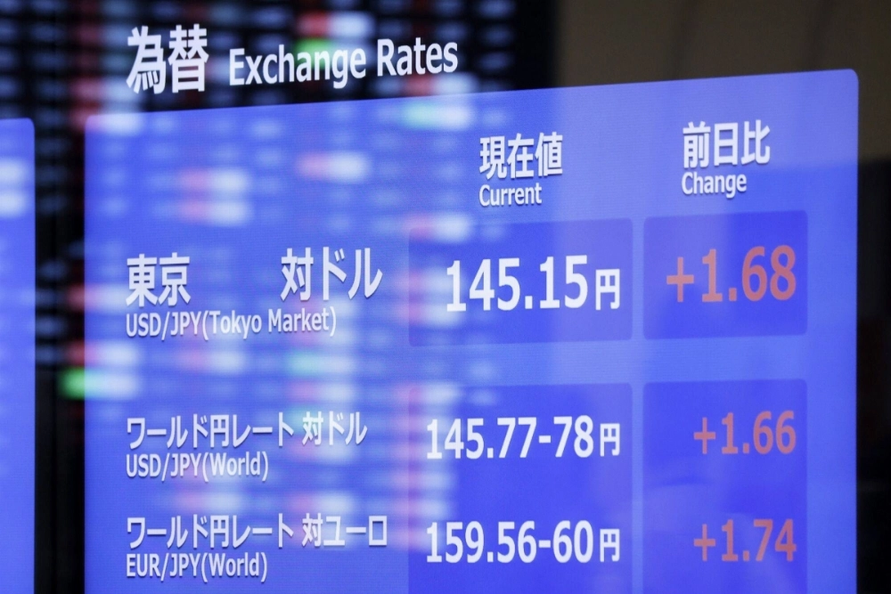 An electric stock board displays the rate of the yen against the U.S. dollar at the Tokyo Stock Exchange in early August. An electric stock board displays the rate of the yen against the U.S. dollar at the Tokyo Stock Exchange in early August.