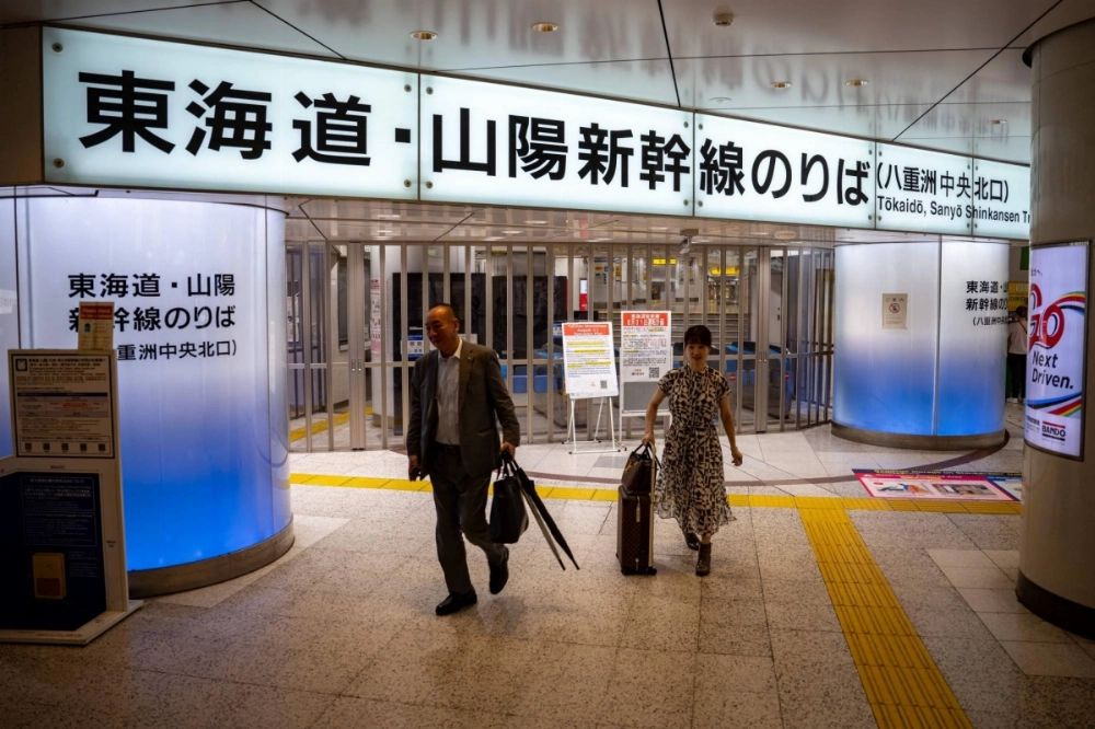 People walk in front of closed ticket gates for the Tokaido Shinkansen in Tokyo Station as train operations between Tokyo and Nagoya remain suspended due to Tropical Storm Shanshan on Saturday. People walk in front of closed ticket gates for the Tokaido Shinkansen in Tokyo Station as train operations between Tokyo and Nagoya remain suspended due to Tropical Storm Shanshan on Saturday.