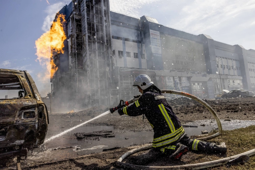 A Ukrainian firefighter works to extinguish a burning car after what Ukrainian officials said was a Russian missile strike in Kharkiv, Ukraine, on Sunday. A Ukrainian firefighter works to extinguish a burning car after what Ukrainian officials said was a Russian missile strike in Kharkiv, Ukraine, on Sunday.