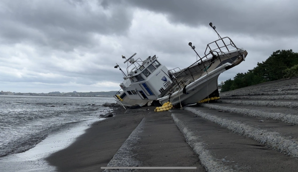 A washed-up boat on the shore of the city of Ibusuki, Kagoshima Prefecture, on Friday A washed-up boat on the shore of the city of Ibusuki, Kagoshima Prefecture, on Friday