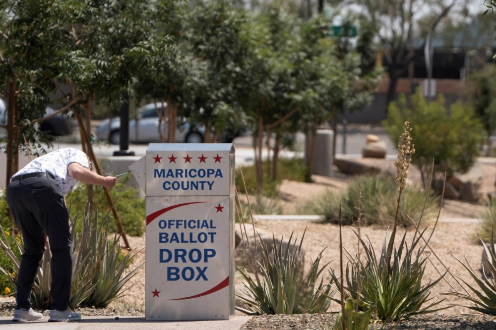 A voter casts a mail-in ballot at a drop box outside the Maricopa County Recorder and Elections Department's southeast Mesa office during the Arizona state primary election in Mesa, Arizona, on July 30. A voter casts a mail-in ballot at a drop box outside the Maricopa County Recorder and Elections Department's southeast Mesa office during the Arizona state primary election in Mesa, Arizona, on July 30.