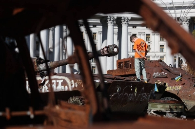 A boy stands on a destroyed Russian tank on display at Mykhailivska Square in Kyiv on Saturday. A boy stands on a destroyed Russian tank on display at Mykhailivska Square in Kyiv on Saturday.