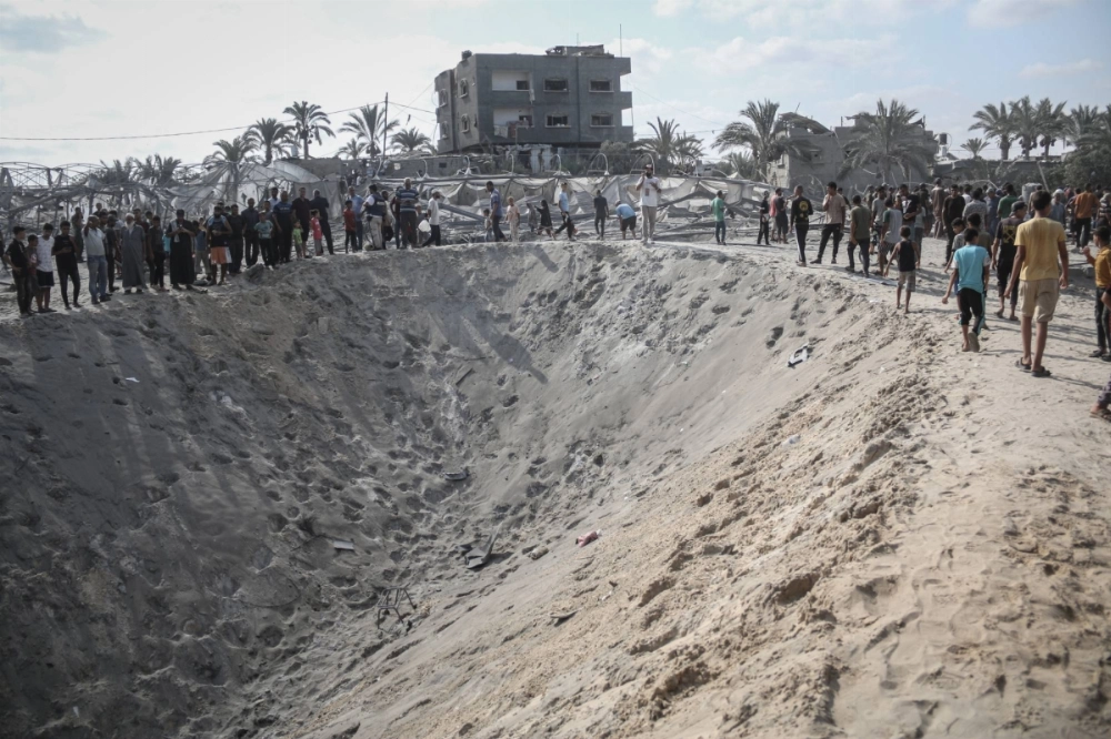 Palestinians look at the destruction following Israeli airstrikes in the humanitarian zone known as Mawasi, in Khan Younis, southern Gaza, on Tuesday. Palestinians look at the destruction following Israeli airstrikes in the humanitarian zone known as Mawasi, in Khan Younis, southern Gaza, on Tuesday.