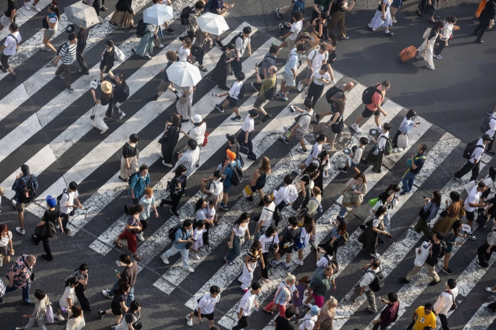 Pedestrians cross an intersection in the Shibuya district of Tokyo. Japan has experienced a postpandemic travel boom, with tourists pouring back in after restrictions closed the country’s borders to travelers. Pedestrians cross an intersection in the Shibuya district of Tokyo. Japan has experienced a postpandemic travel boom, with tourists pouring back in after restrictions closed the country’s borders to travelers.