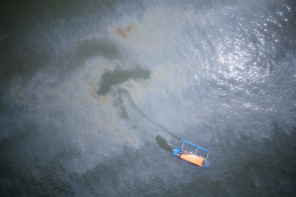 An oil slick in the waters off the coast of Manila Bay, in Pamarawan, Malolos, Bulacan province, Philippines, on July 29.  An oil slick in the waters off the coast of Manila Bay, in Pamarawan, Malolos, Bulacan province, Philippines, on July 29.