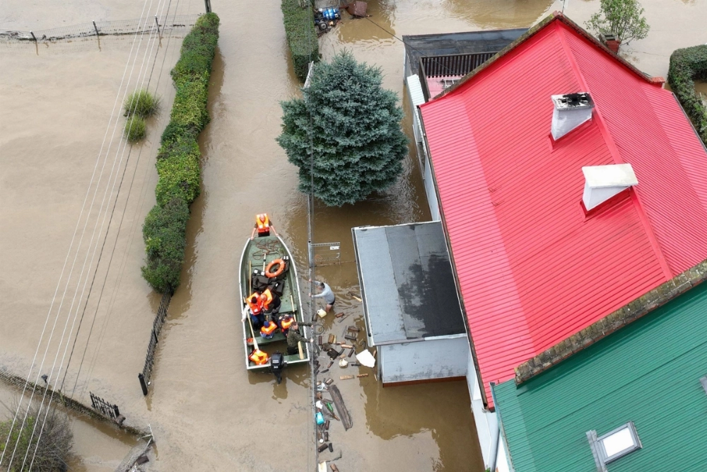 Local residents are evacuated by Polish rescuers in the village of Rudawa, southern Poland, on Sunday. Local residents are evacuated by Polish rescuers in the village of Rudawa, southern Poland, on Sunday.
