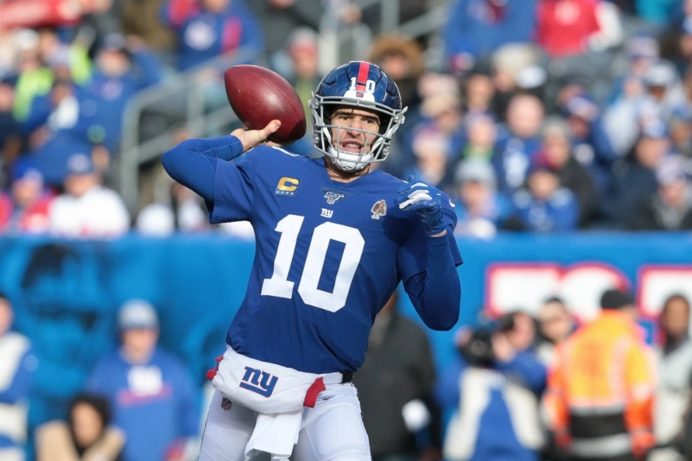 Giants quarterback Eli Manning drops back to pass during a game against the Dolphins in December 2019.  Giants quarterback Eli Manning drops back to pass during a game against the Dolphins in December 2019.
