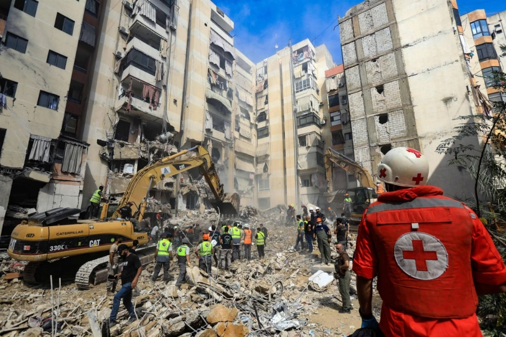 Rescuers sift through the rubble Saturday at the scene of an Israeli strike that targeted Beirut's southern suburbs a day earlier. Rescuers sift through the rubble Saturday at the scene of an Israeli strike that targeted Beirut's southern suburbs a day earlier.