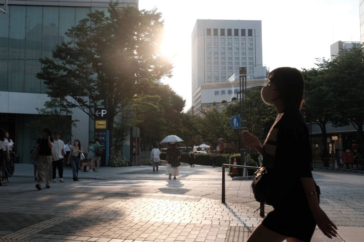 People walk through the Yurakucho district of Tokyo on July 4. A panel of researchers recently announced that Japan’s record heat in July was “almost impossible” without global warming. People walk through the Yurakucho district of Tokyo on July 4. A panel of researchers recently announced that Japan’s record heat in July was “almost impossible” without global warming.