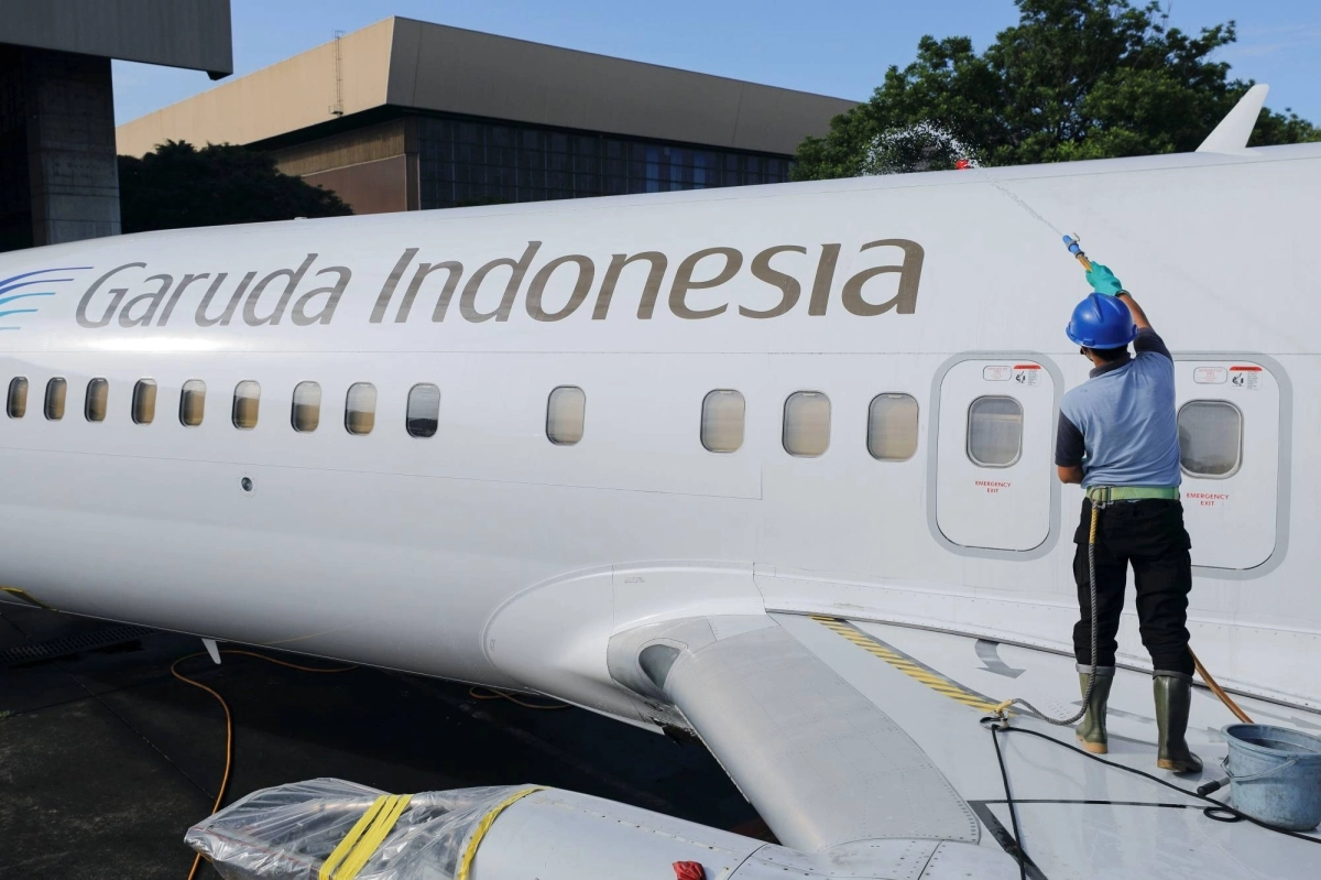 A worker cleans a Garuda Indonesia aircraft parked at Soekarno-Hatta International Airport near Jakarta in 2022. Garuda said it’s operating user-preferred routing on flights from Jakarta to Sydney and Melbourne. A worker cleans a Garuda Indonesia aircraft parked at Soekarno-Hatta International Airport near Jakarta in 2022. Garuda said it’s operating user-preferred routing on flights from Jakarta to Sydney and Melbourne.