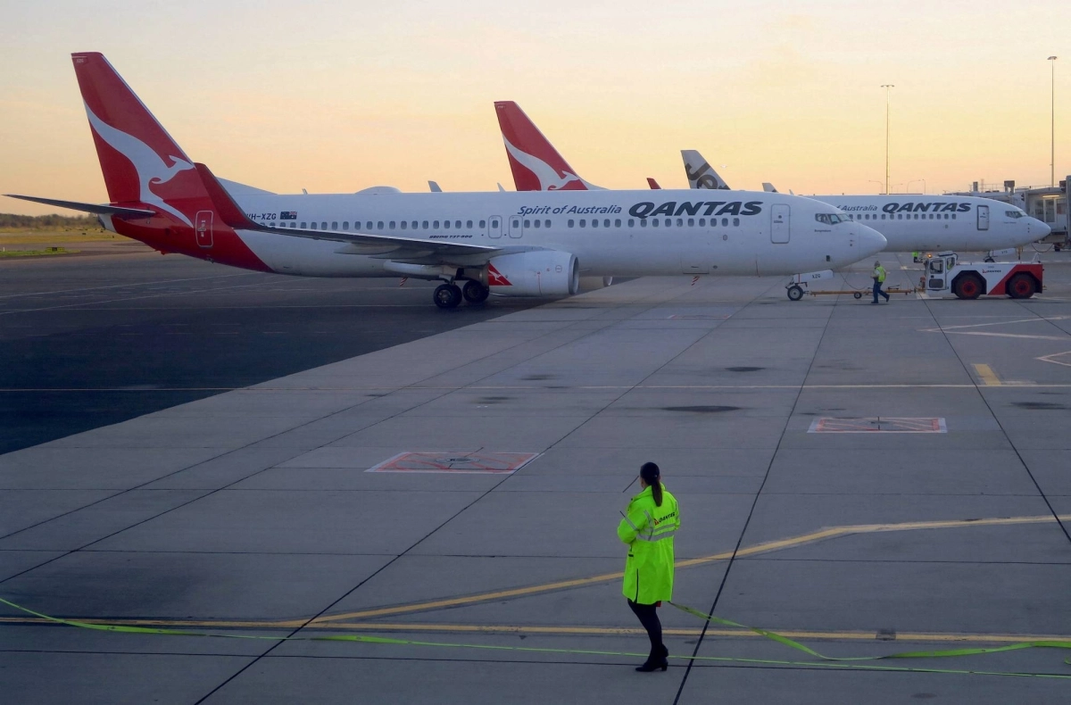 Workers are seen near Qantas Airways' Boeing 737-800 aircraft on the tarmac of Adelaide Airport, Australia, in 2018. Qantas is one of four airlines involved in the trial. Workers are seen near Qantas Airways' Boeing 737-800 aircraft on the tarmac of Adelaide Airport, Australia, in 2018. Qantas is one of four airlines involved in the trial.