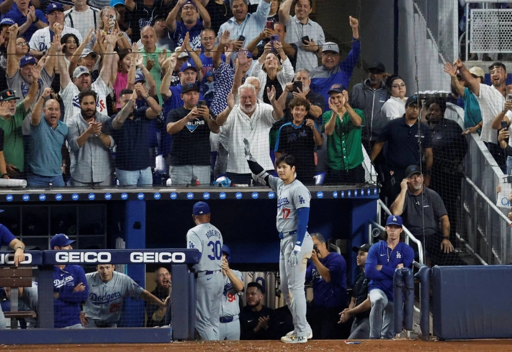 Shohei Ohtani reacts to a standing ovation from fans after hitting his 50th home run of the season on Sept. 19.  Shohei Ohtani reacts to a standing ovation from fans after hitting his 50th home run of the season on Sept. 19.