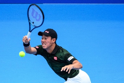 Kei Nishikori hits a return against Jordan Thompson during their second-round match at the Japan Open in Tokyo on Saturday.  Kei Nishikori hits a return against Jordan Thompson during their second-round match at the Japan Open in Tokyo on Saturday.