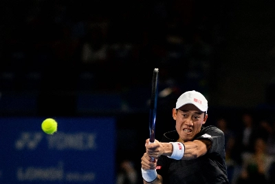 Kei Nishikori hits a return against Holger Rune during their Japan Open quarterfinal match on Sunday. Kei Nishikori hits a return against Holger Rune during their Japan Open quarterfinal match on Sunday.