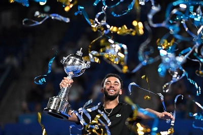 France's Arthur Fils celebrates with the winner's trophy after his victory over Ugo Humbert in the men's singles final of the Japan Open in Tokyo on Tuesday.  France's Arthur Fils celebrates with the winner's trophy after his victory over Ugo Humbert in the men's singles final of the Japan Open in Tokyo on Tuesday.