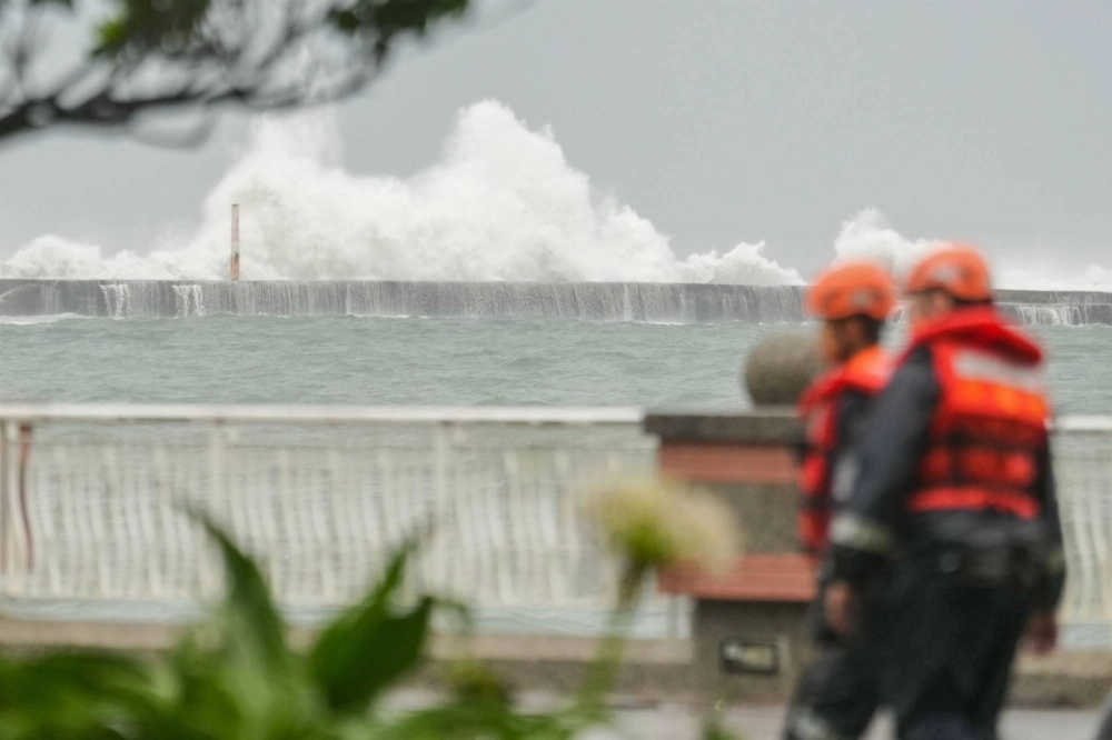 Members of the Taiwan Coast Guard walk along the coast at Sizihwan beach in Kaohsiung on Wednesday. Typhoon Krathon is forecast to hit between Kaohsiung and its neighboring city of Tainan in the early hours of Thursday, then work its way up the west coast toward the capital Taipei.  Members of the Taiwan Coast Guard walk along the coast at Sizihwan beach in Kaohsiung on Wednesday. Typhoon Krathon is forecast to hit between Kaohsiung and its neighboring city of Tainan in the early hours of Thursday, then work its way up the west coast toward the capital Taipei.