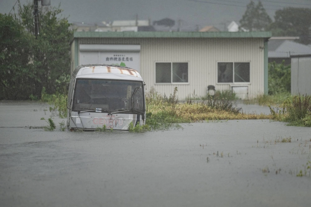 A bus is seen submerged in floodwaters in Yufu, Oita Prefecture, on Aug. 29 as Typhoon Shanshan dumps torrential rain across southern regions of Japan. A bus is seen submerged in floodwaters in Yufu, Oita Prefecture, on Aug. 29 as Typhoon Shanshan dumps torrential rain across southern regions of Japan.