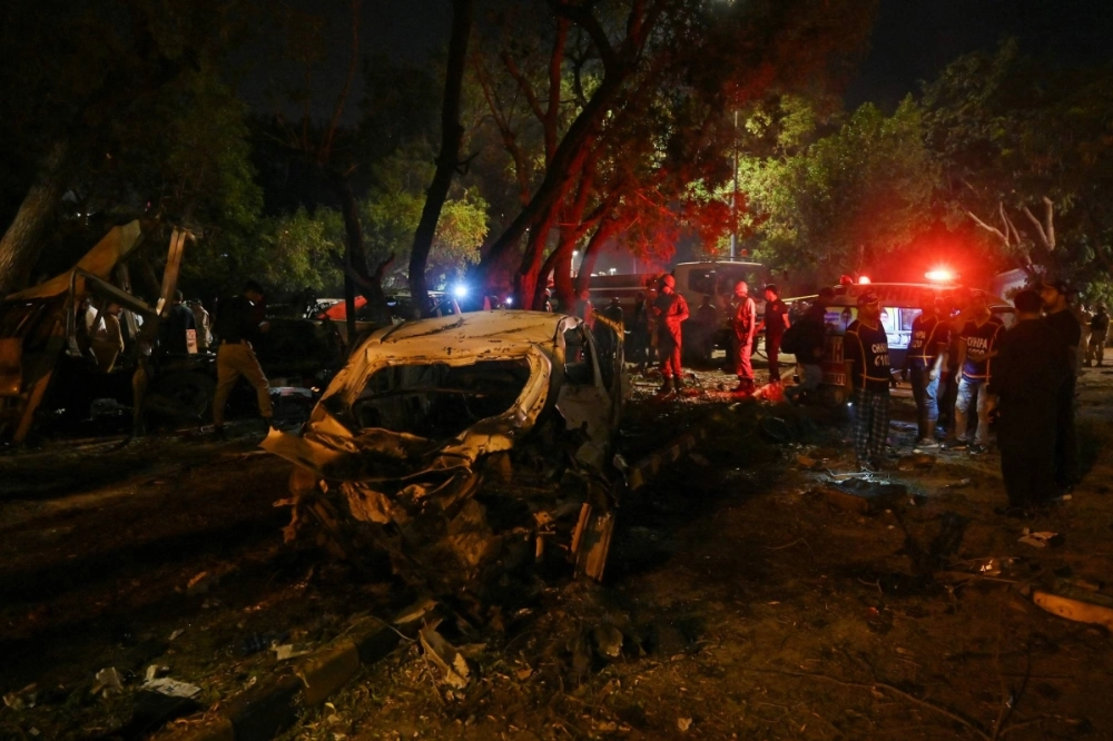 Security officials examine the site of an explosion near Karachi's international airport in the Pakistani city on Sunday. Security officials examine the site of an explosion near Karachi's international airport in the Pakistani city on Sunday.