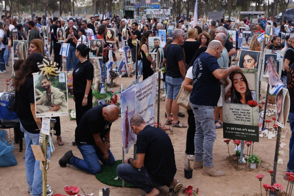 People mourn at the site of the Nova music festival, the location of a deadly attack by Hamas on Oct. 7 of last year, near Kibbutz Reim, Israel, on Monday. People mourn at the site of the Nova music festival, the location of a deadly attack by Hamas on Oct. 7 of last year, near Kibbutz Reim, Israel, on Monday.