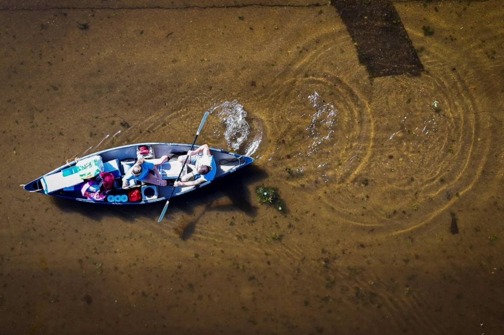 An aerial view shows people paddling through a flooded street in South Daytona, Florida, following the passage of Hurricane Milton on Friday. An aerial view shows people paddling through a flooded street in South Daytona, Florida, following the passage of Hurricane Milton on Friday.