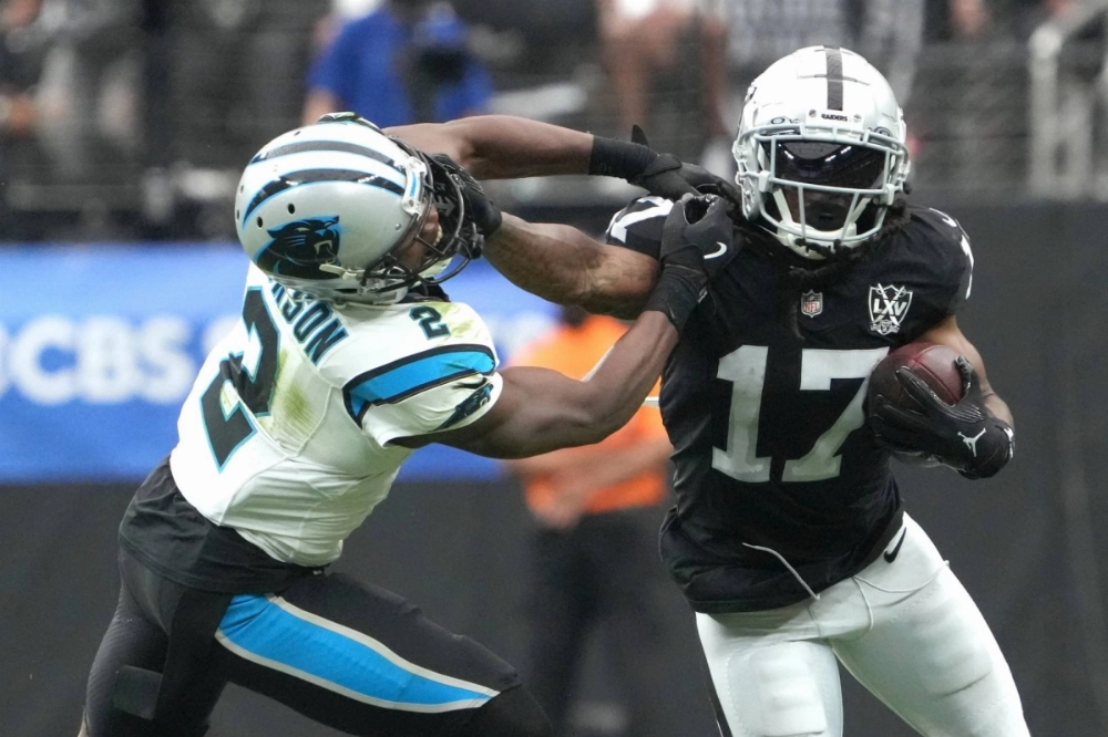 Raiders receiver Davante Adams carries the ball against the Panthers during their game on Sept. 22. Adams was traded to the Jets on Tuesday and is expected to make his debut with the team on Sunday.  Raiders receiver Davante Adams carries the ball against the Panthers during their game on Sept. 22. Adams was traded to the Jets on Tuesday and is expected to make his debut with the team on Sunday.
