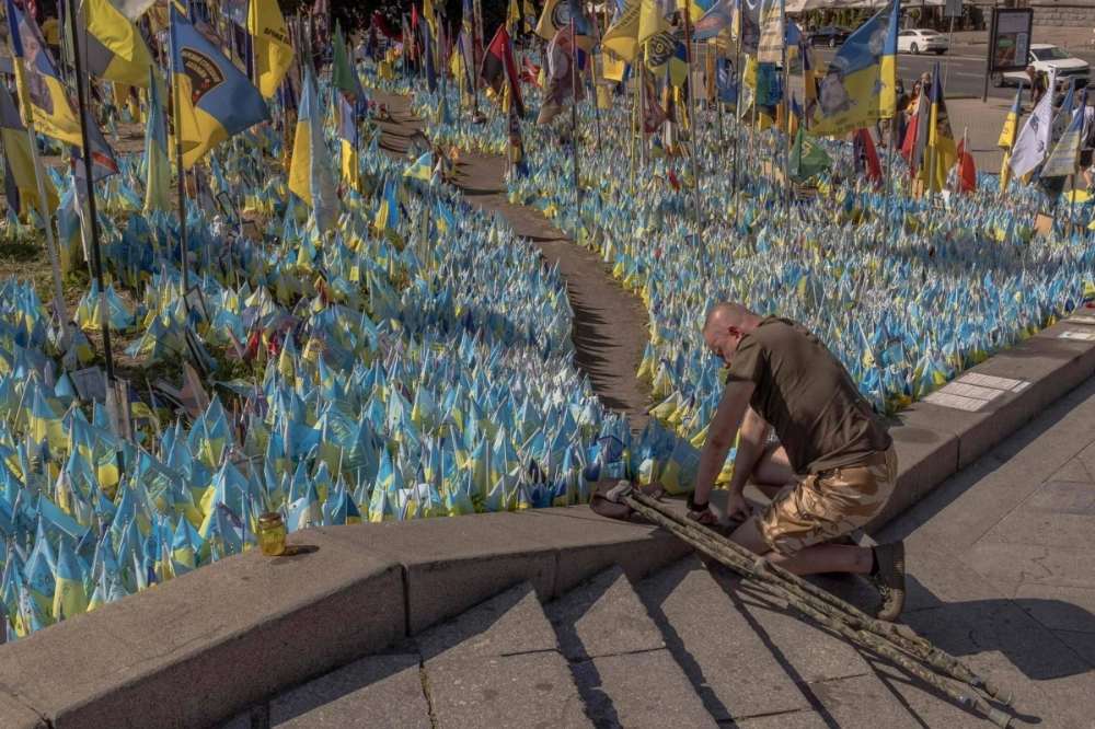 A man kneels down at a designated area for commemorating fallen Ukrainian fighters in Kyiv. Ukraine's population has declined by 10 million since Russia invaded in February 2022, the United Nations said Tuesday. A man kneels down at a designated area for commemorating fallen Ukrainian fighters in Kyiv. Ukraine's population has declined by 10 million since Russia invaded in February 2022, the United Nations said Tuesday.