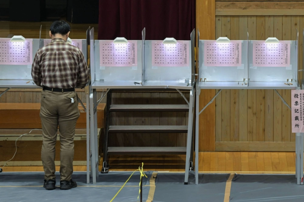 A man votes in the Lower House election at a polling station set up at a school  in Tokyo on Sunday. A man votes in the Lower House election at a polling station set up at a school  in Tokyo on Sunday.