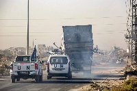 United Nations' vehicles escort a damaged truck that was reportedly used by workers of the U.N. Relief and Works Agency for Palestine Refugees in the Near East, in Gaza last week. | AFP-Jiji