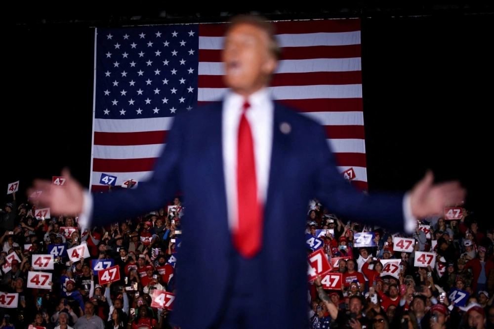 Supporters react as Republican presidential nominee and former U.S. President Donald Trump speaks during a campaign rally in Novi, Michigan, on Saturday. Supporters react as Republican presidential nominee and former U.S. President Donald Trump speaks during a campaign rally in Novi, Michigan, on Saturday.