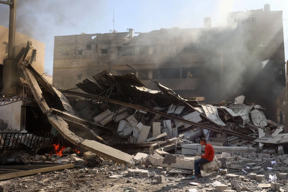 A Palestinian boy sits on rubble following an Israeli strike on the Maghazi refugee camp in the Gaza Strip on Thursday. A Palestinian boy sits on rubble following an Israeli strike on the Maghazi refugee camp in the Gaza Strip on Thursday.