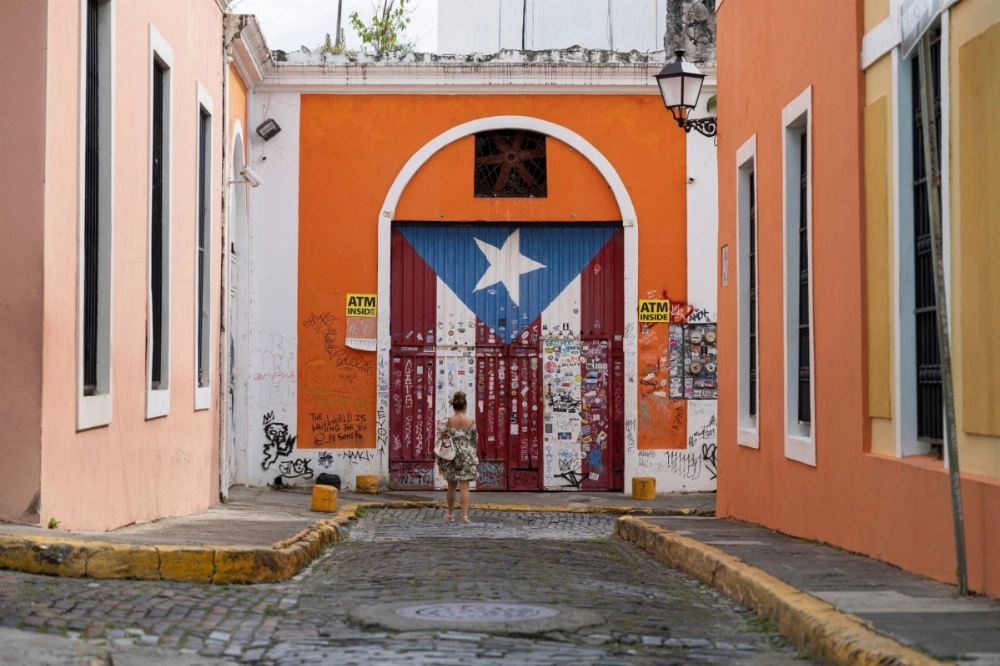 A woman takes photos of a gate in Old San Juan, Puerto Rico, on Monday. Comedian Tony Hinchcliffe, at a Donald Trump event on Sunday, called Puerto Rico a "floating island of garbage." A woman takes photos of a gate in Old San Juan, Puerto Rico, on Monday. Comedian Tony Hinchcliffe, at a Donald Trump event on Sunday, called Puerto Rico a "floating island of garbage."