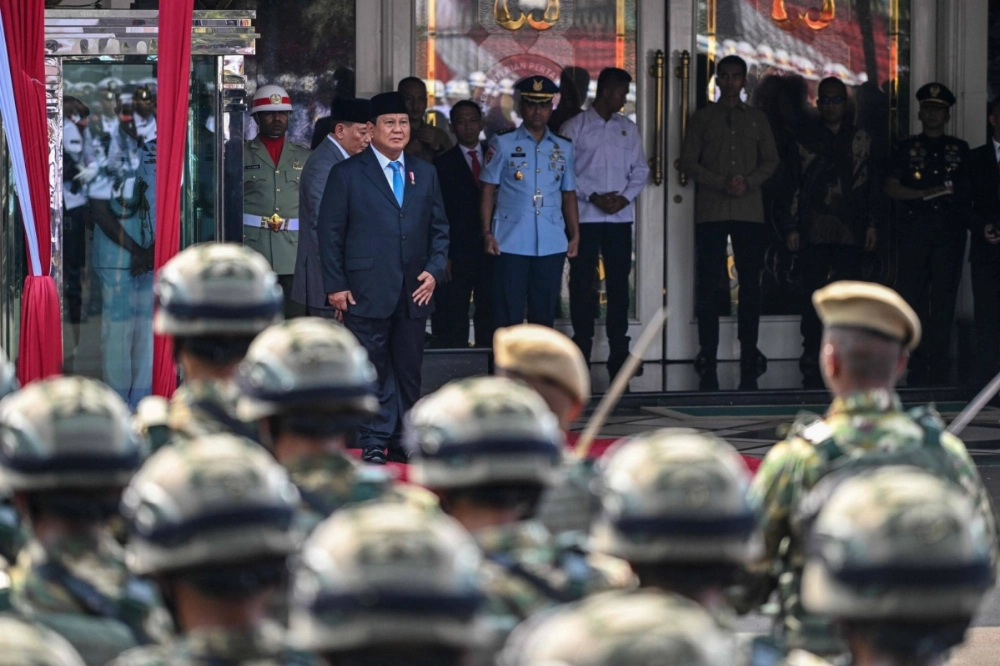 Indonesia's President Prabowo Subianto (front) stands next to Indonesia's new Defense Minister Sjafrie Sjamsoeddin during a handover ceremony at the Ministry of Defense in Jakarta on Oct. 22. Indonesia's President Prabowo Subianto (front) stands next to Indonesia's new Defense Minister Sjafrie Sjamsoeddin during a handover ceremony at the Ministry of Defense in Jakarta on Oct. 22.