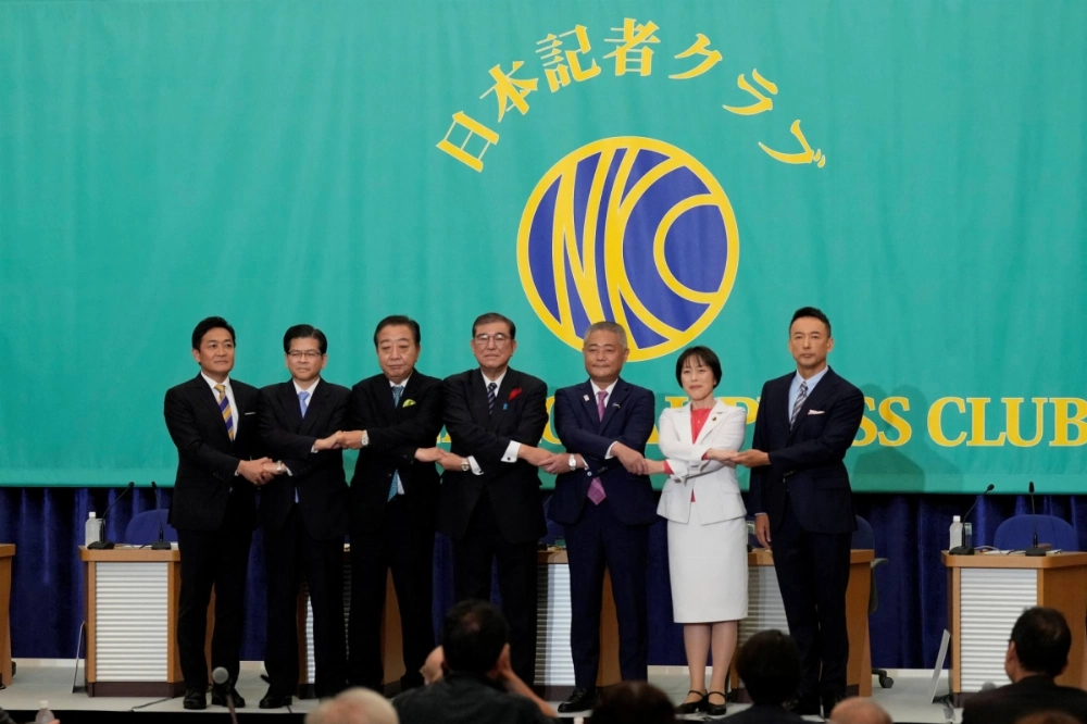 Leaders of Japan’s political parties pose for a group photo at the start of a debate at the Japan National Press Club in Tokyo on Oct. 12. Sunday’s Lower House election saw the ruling coalition led by the Liberal Democratic Party take a drubbing. Leaders of Japan’s political parties pose for a group photo at the start of a debate at the Japan National Press Club in Tokyo on Oct. 12. Sunday’s Lower House election saw the ruling coalition led by the Liberal Democratic Party take a drubbing.