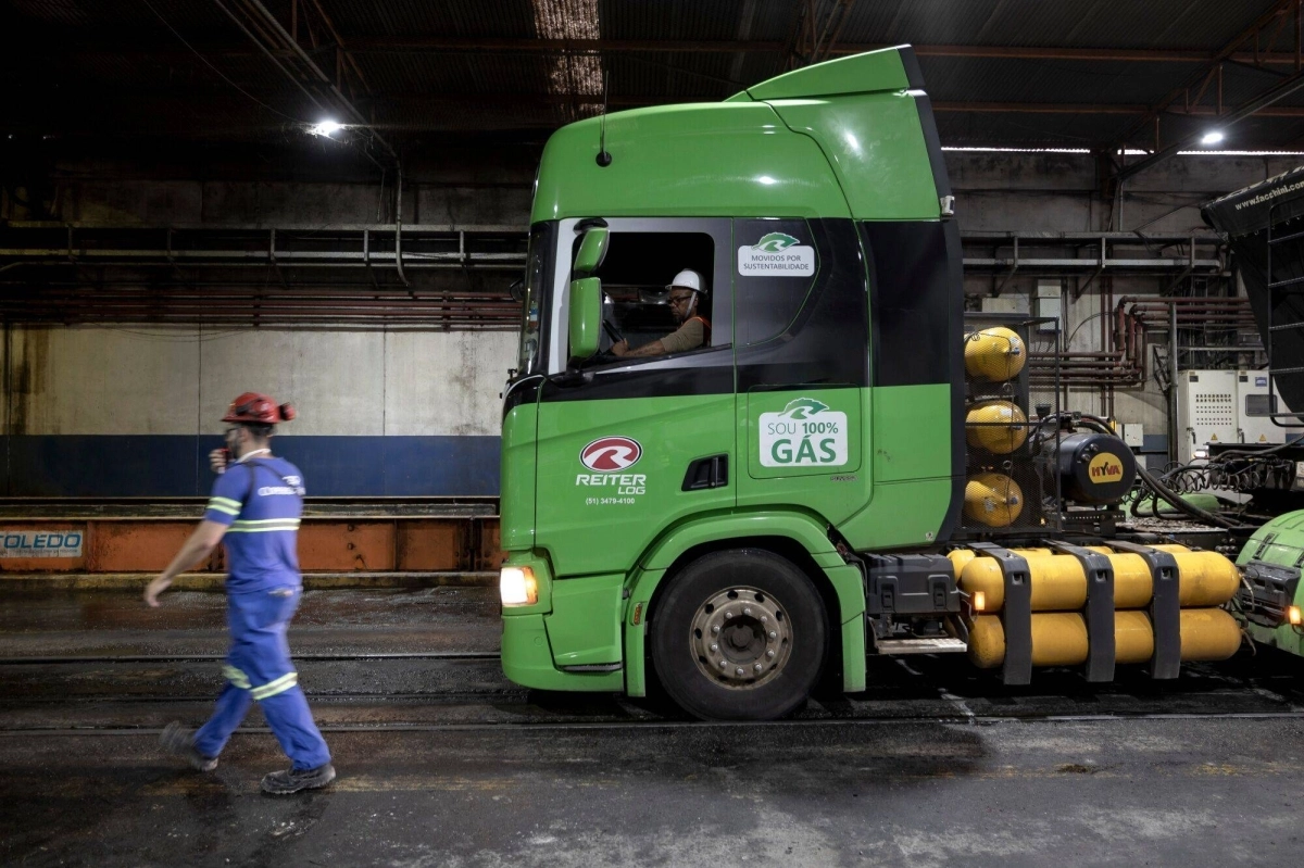 Workers prepare to unload a truck powered by biomethane fuel in the Copersucar SA sugar terminal at the Port of Santos in Santos, Brazil, on Oct. 25. Workers prepare to unload a truck powered by biomethane fuel in the Copersucar SA sugar terminal at the Port of Santos in Santos, Brazil, on Oct. 25.