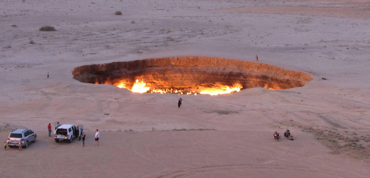 A photo taken on May 3, 2014, shows people visiting the Gates of Hell, a huge burning gas crater in the heart of Turkmenistan's Karakum desert. Turkmenistan said on Oct. 25 that it will capture the gas fueling the area, putting the human-made fire pit at risk of closure as the reclusive state seeks to reduce its greenhouse emissions. A photo taken on May 3, 2014, shows people visiting the Gates of Hell, a huge burning gas crater in the heart of Turkmenistan's Karakum desert. Turkmenistan said on Oct. 25 that it will capture the gas fueling the area, putting the human-made fire pit at risk of closure as the reclusive state seeks to reduce its greenhouse emissions.