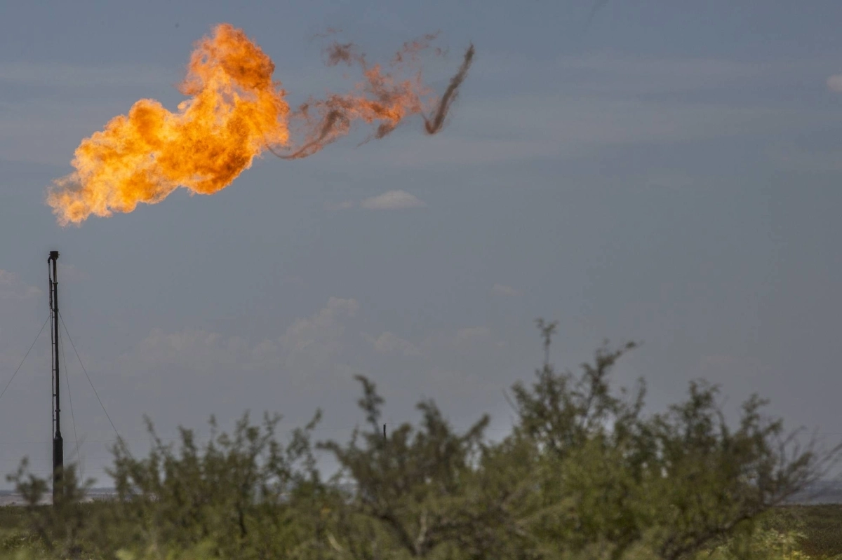 A gas flare is seen in a field near Mentone, Texas, on Aug. 31, 2019. A gas flare is seen in a field near Mentone, Texas, on Aug. 31, 2019.