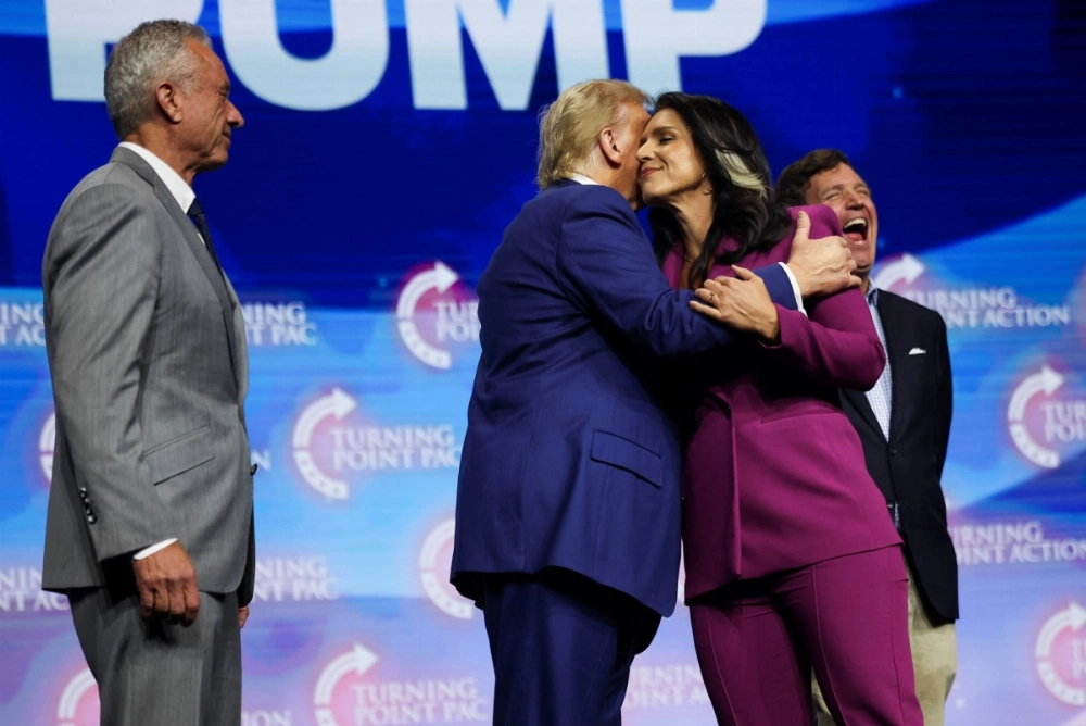 Donald Trump is joined on stage by former U.S. Rep. Tulsi Gabbard and Robert F. Kennedy Jr. at a campaign event in Duluth, Georgia, on Oct. 23. Donald Trump is joined on stage by former U.S. Rep. Tulsi Gabbard and Robert F. Kennedy Jr. at a campaign event in Duluth, Georgia, on Oct. 23.